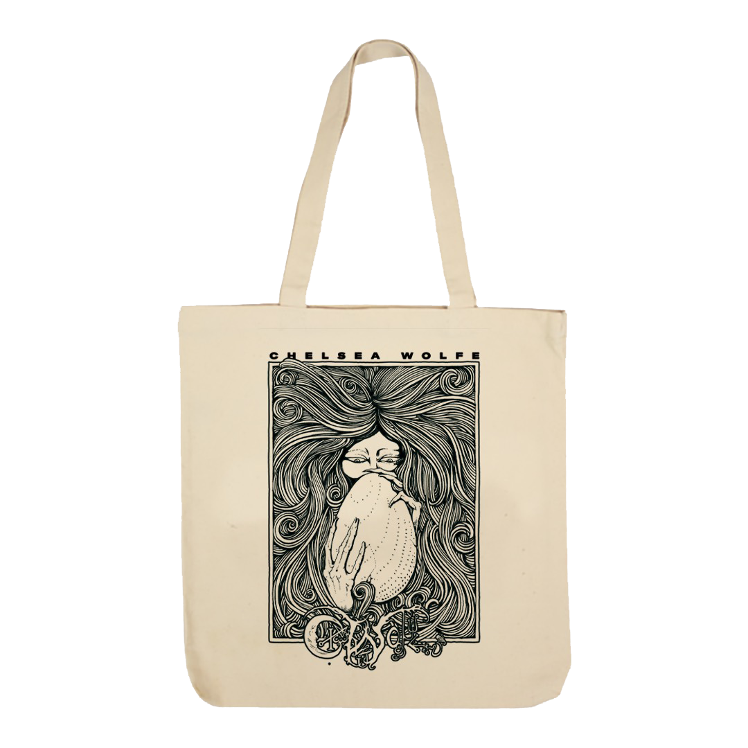 A natural canvas tote bag with a black graphic print of a cat with long hair and the text 'CHELSEA WOLFE' on the front, shown against a plain white background.