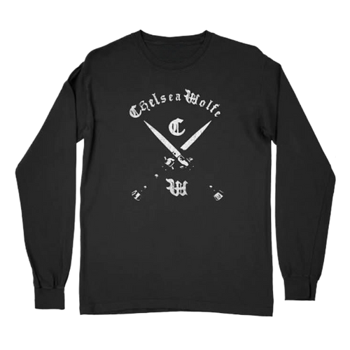 A black long-sleeve t-shirt with a white graphic print on the front featuring the text 'Chelsea Wolfe' in a gothic font above crossed knives and monogram letters, displayed on a solid white background.